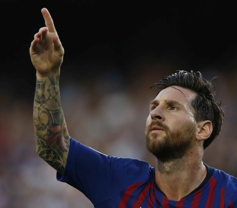 El argentino Lionel Messi festeja luego de anotar el primer tanto del Barcelona ante el PSV de Eindhoven, en un partido de la Liga de Campeones de Europa (semisquare-x3)