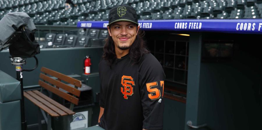 El pitcher de los Gigantes de San Francisco, el puertorriqueño Dereck Rodríguez, quien fue llamado de la sucursal Triple-A Sacramento, sale para calentar en Coors Field antes del juego ante los Rockies de Colorado en Denver. (AP) (horizontal-x3)