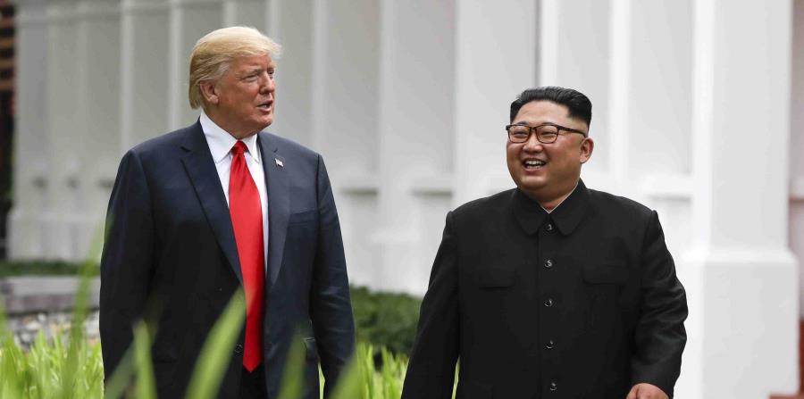 El presidente de Estados Unidos, Donald Trump, y el líder de Corea del Norte, Kim Jong Un, caminan por el balneario Capella, en la isla de Sentosa, tras una comida de trabajo, el 12 de junio de 2018 en Singapore. (AP (horizontal-x3)
