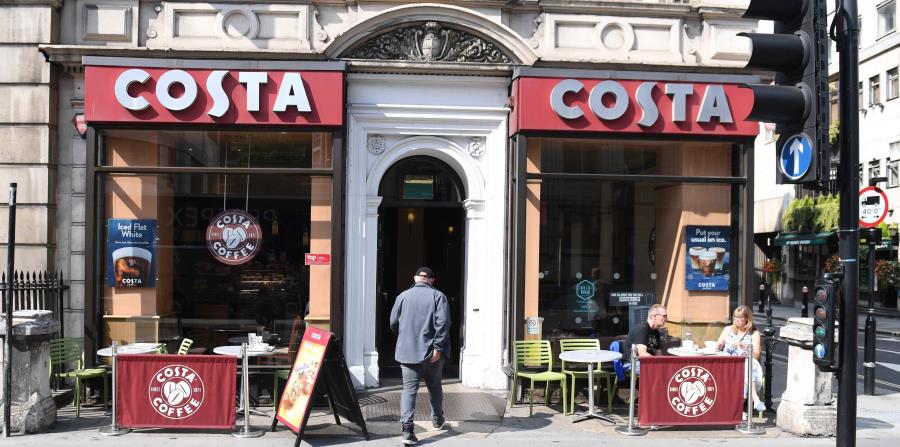Un cliente entra a la tienda británica Costa. (EFE) (horizontal-x3)