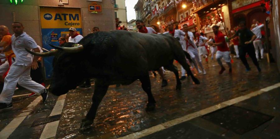 Un grupo de mozos corre junto a toros de la ganadería José Escolar en el segundo encierro de las fiestas de San Fermín (horizontal-x3)