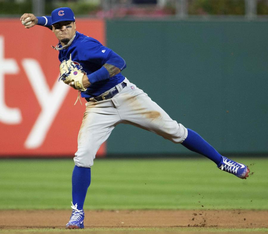 Javier Báez realiza una jugada durante la quinta entrada del partido. (AP) (semisquare-x3)