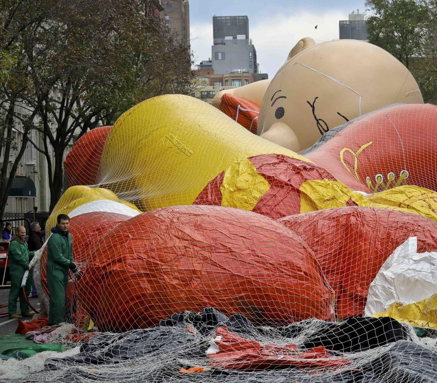 Operarios inflan globos gigantes, incluyendo uno con la imagen de Charlie Brown, en la víspera de su participación en la 92da edición del Desfile del Día de Gracias de Macy’s, el 21 de noviembre de 2018, en Nueva York (semisquare-x3)